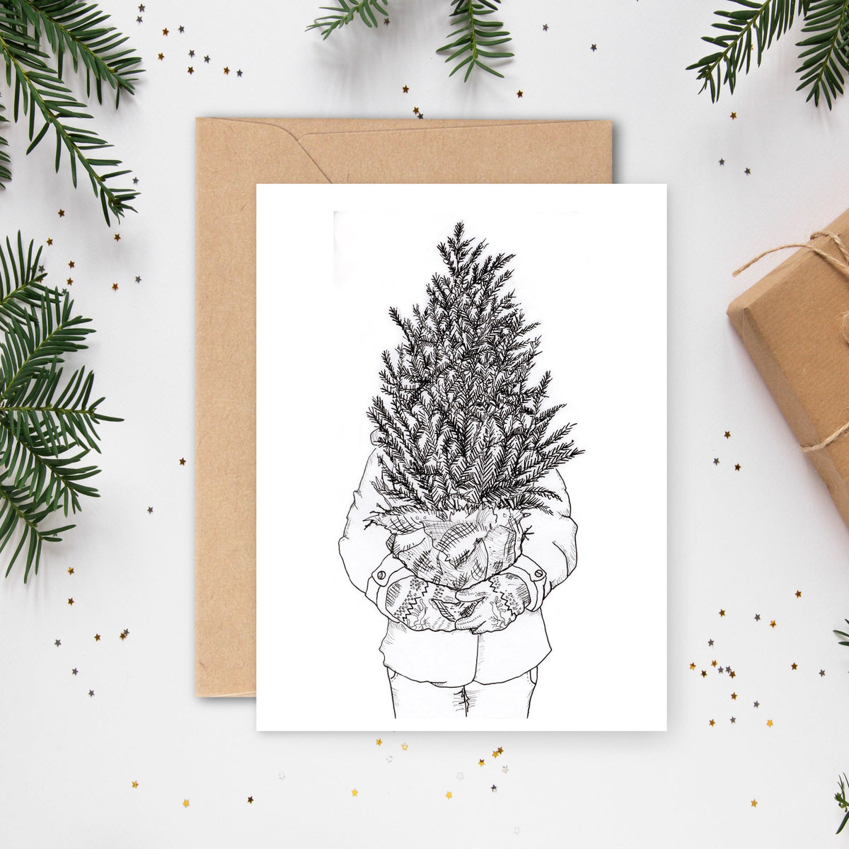 kerstkaart | pentekening / persoon met een kerstboom in de armen / Vrolijk Illustratie | Studio Springer